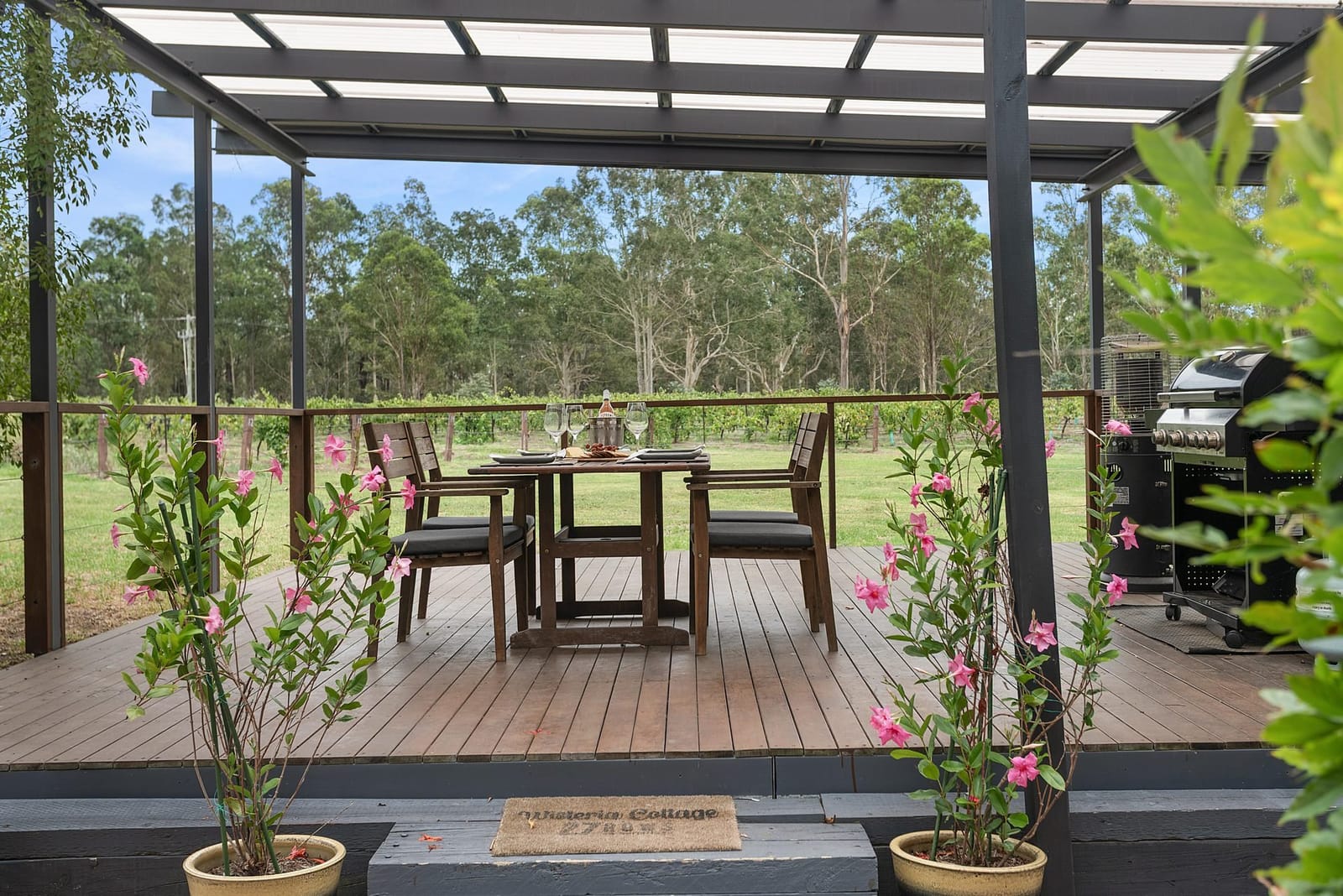 Wisteria cottage and its deck lit at dusk