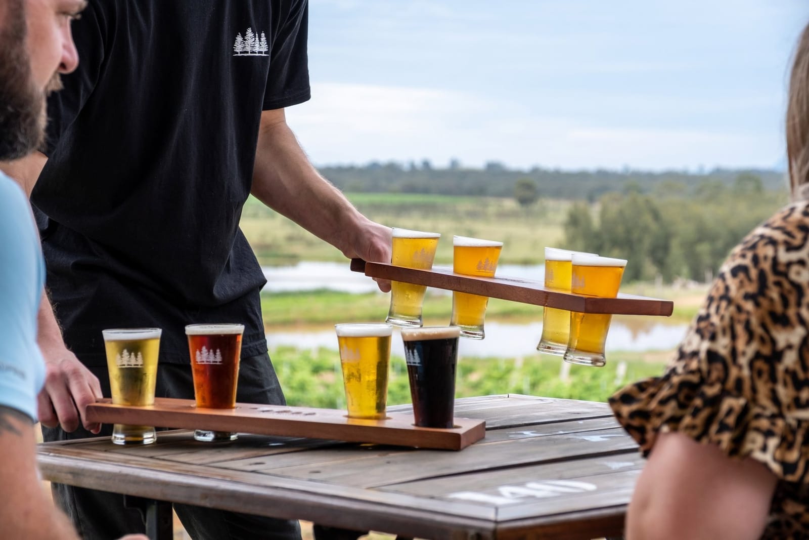 A tasting paddle of 4 Pines beers served on the terrace above the lake