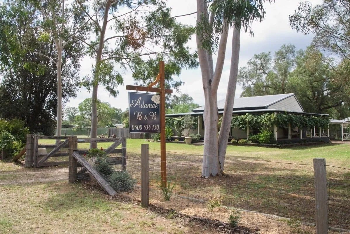 The B&B sign at the gate with the verandahed cottage at Adamae, Broke, Hunter Valley
