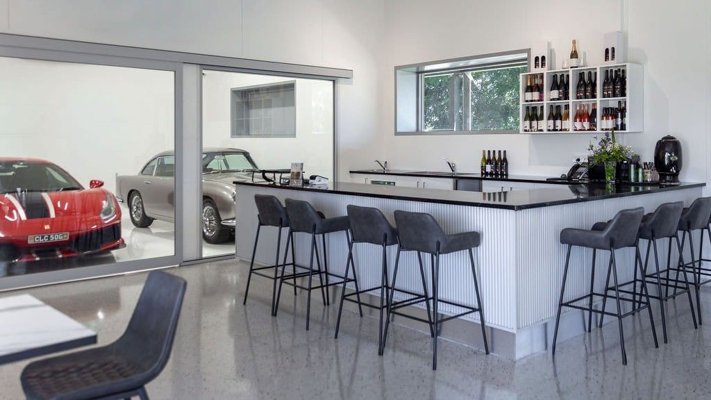 Modern tasting room with white counter and wine bottle displays