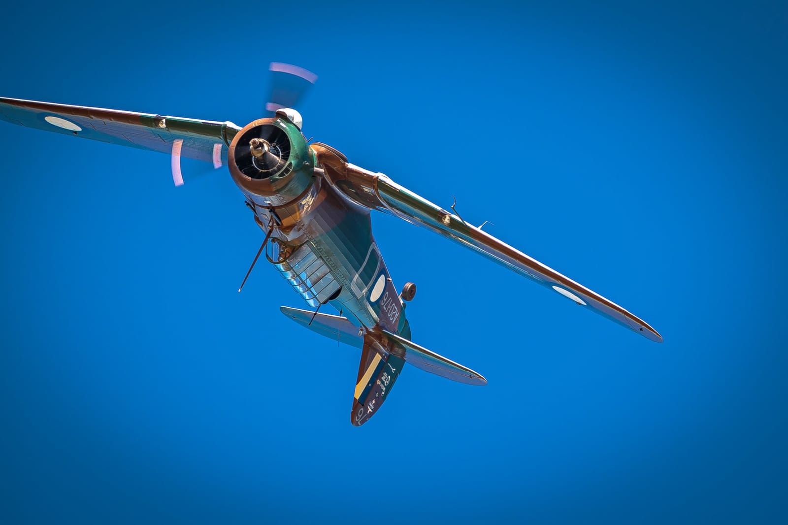 Twin-engine aircraft viewed from below against clear blue sky at AeroHunter Adventure Flights, Pokolbin, Hunter Valley