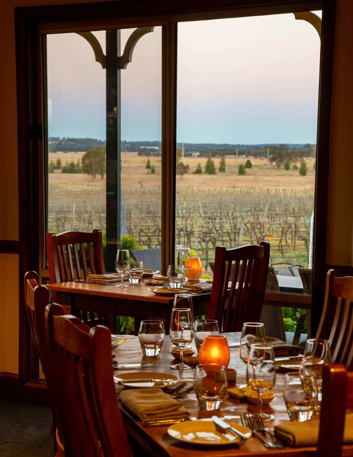 Dining room with tables beside a window overlooking the vines at Amanda's on the Edge, Pokolbin, Hunter Valley