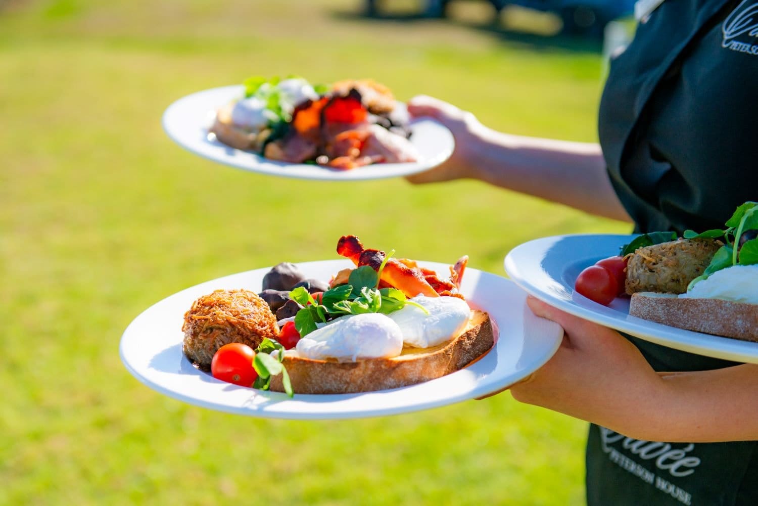 Outdoor catering with fresh eggs on toast and seasonal vegetables