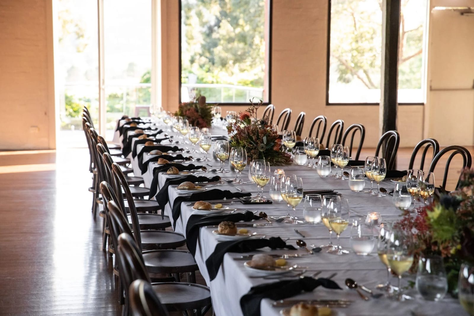 Formal dining table set with black napkins and white cloths