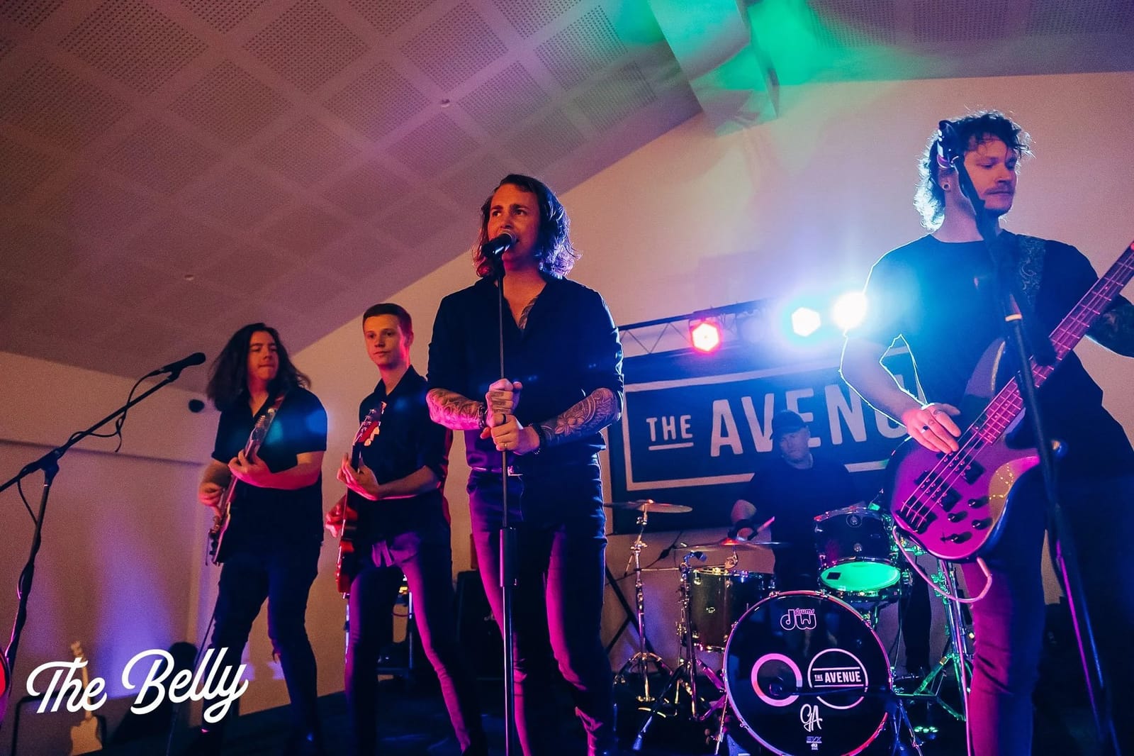 Live band performing with coloured stage lighting at venue