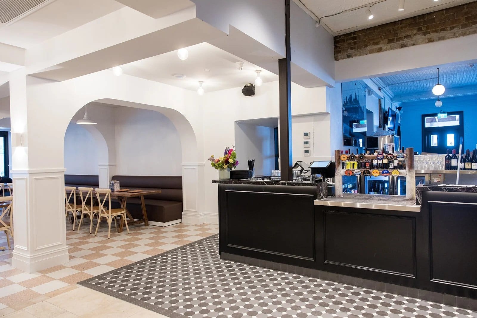Modern hotel bar with black counter and white decorative features at Bellbird Hotel, Bellbird, Hunter Valley