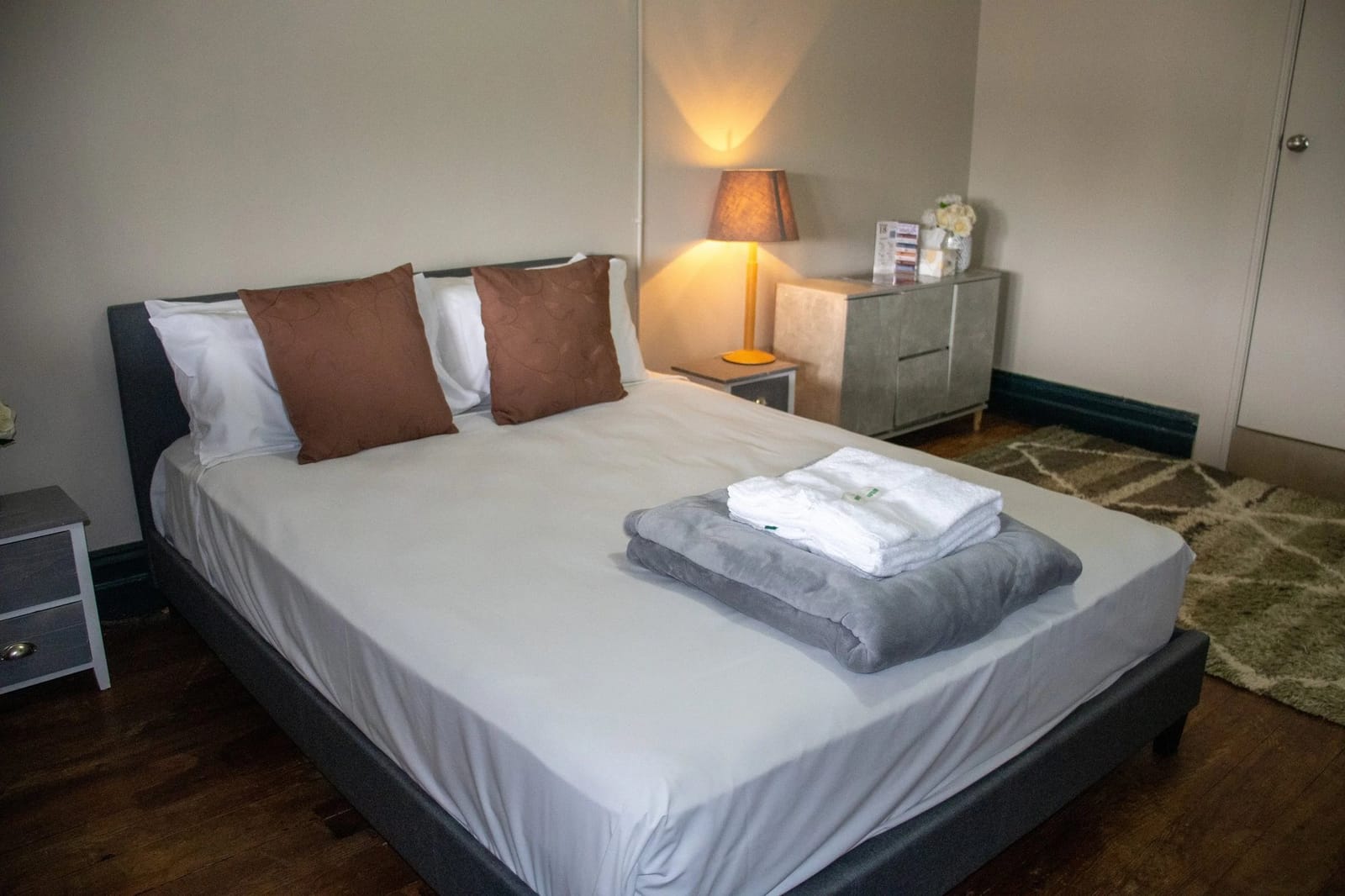 Modern guest bedroom with queen bed and neutral decor