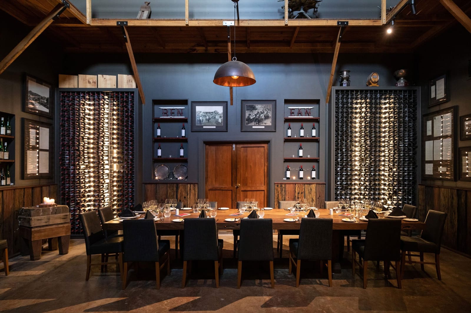 Private dining room with wine display walls and long wooden table