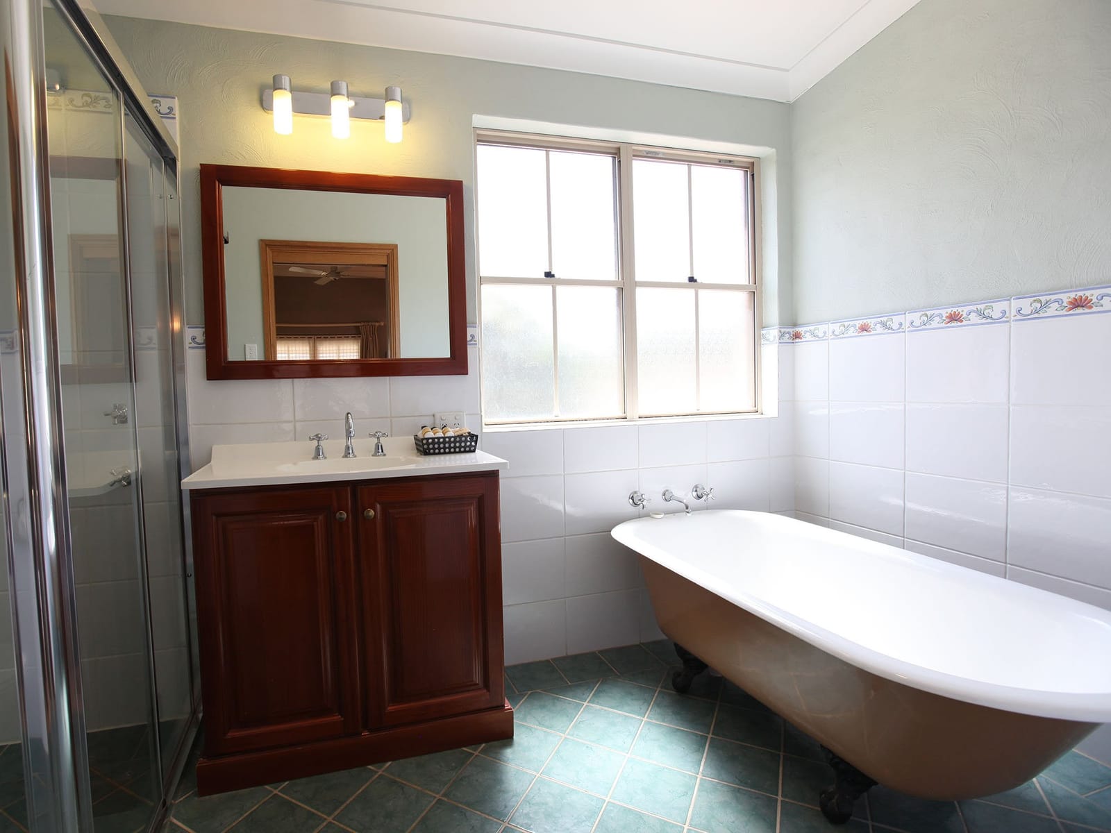 Claw-foot bath and shower in a one-bedroom cottage