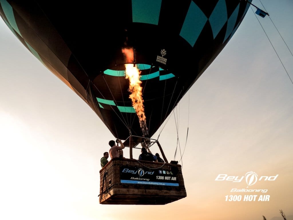 Close-up of the basket and burner with passengers aboard at sunrise