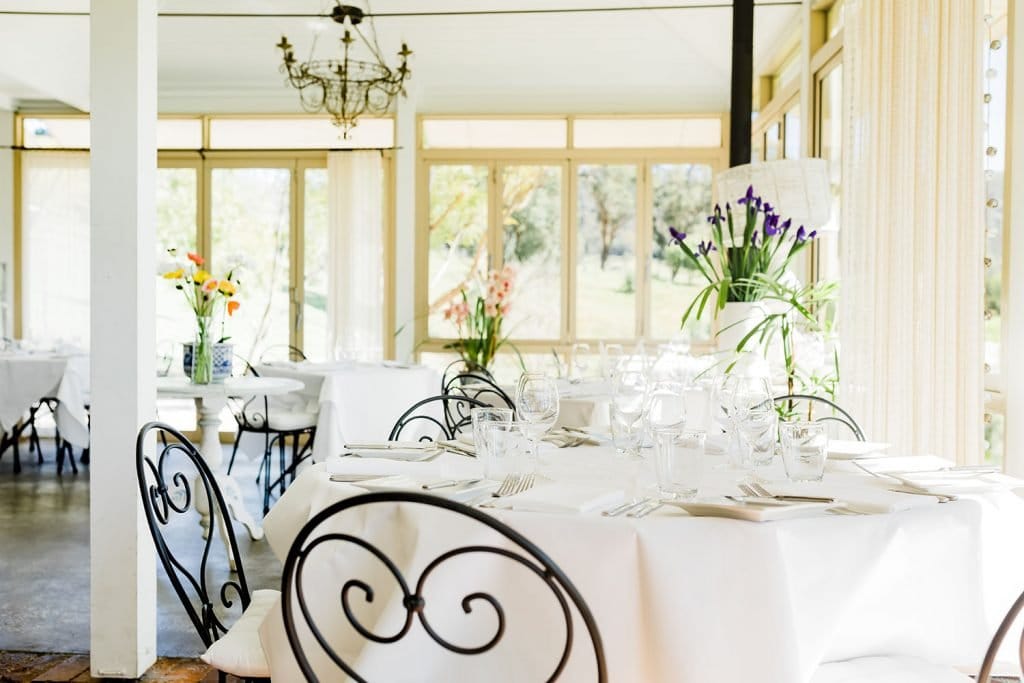 Formal dining room with white tablecloths and floral arrangements