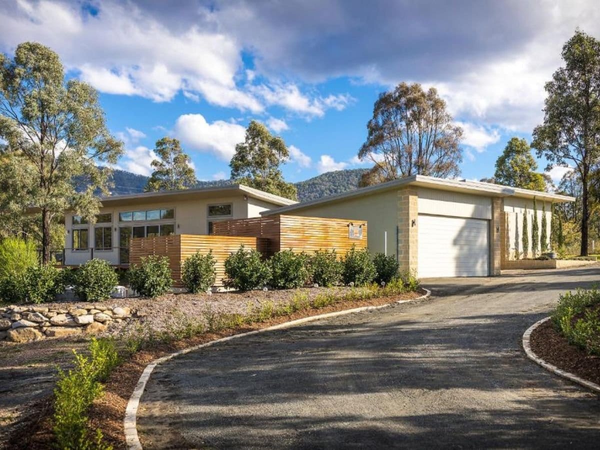 Modern cottage exterior with mountain views surrounded by trees at Blue Cliff Retreat, Pokolbin, Hunter Valley