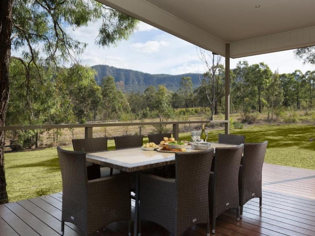 Timber deck dining area with mountain views and surrounding bushland