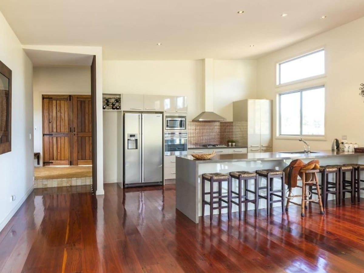 Kitchen and living area with modern appliances and large windows