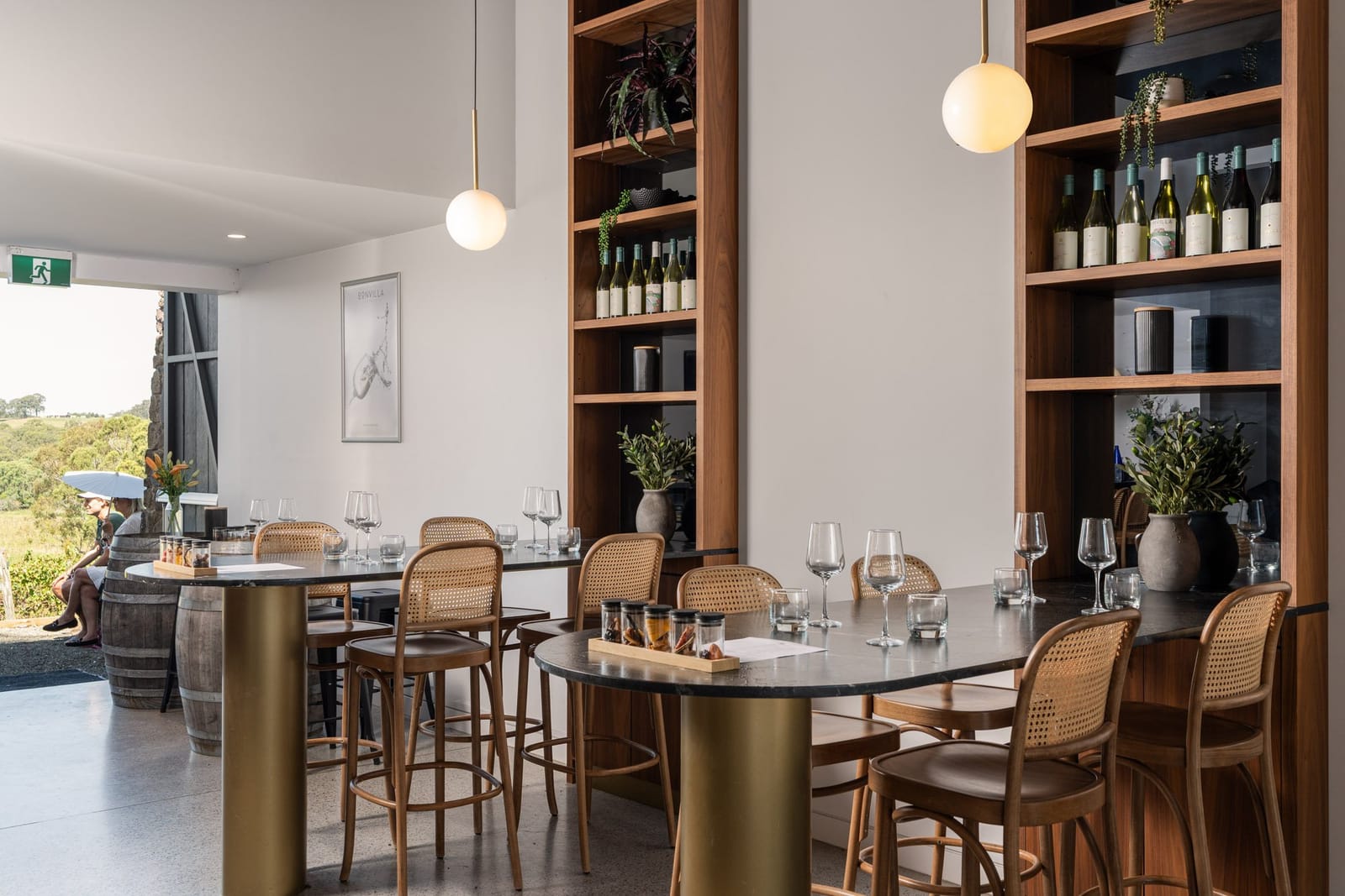Modern cellar door interior with wooden shelving and wine display