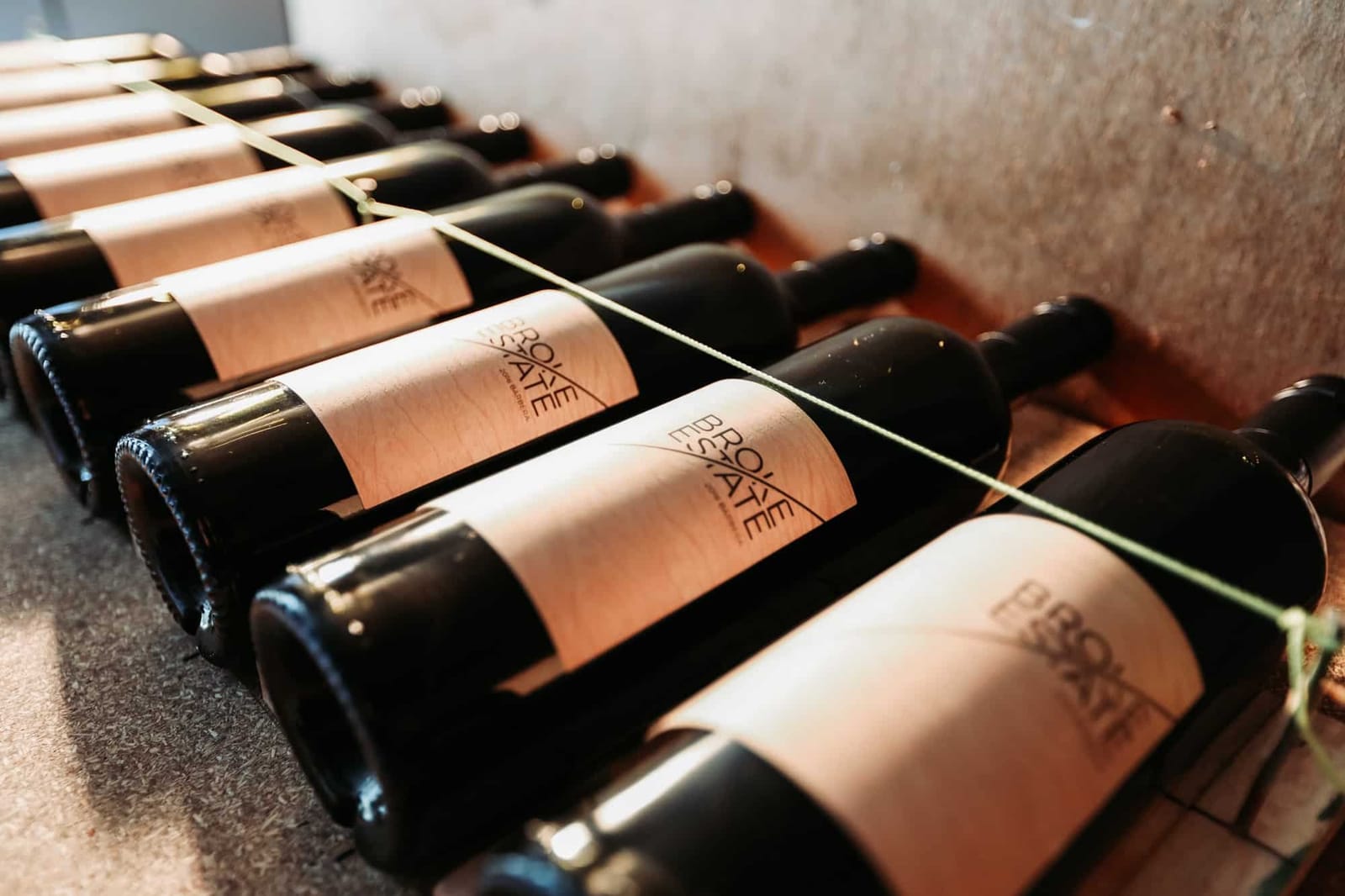 Broke Estate bottles stacked in a rack