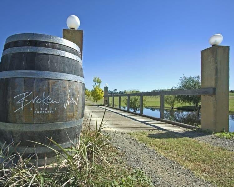 Entrance sign on wine barrel beside timber bridge over the dam at Broken View, Rothbury, Hunter Valley