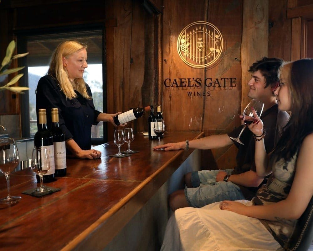 Wooden cellar door interior with wine counter and logo sign at Cael's Gate, Broke, Hunter Valley