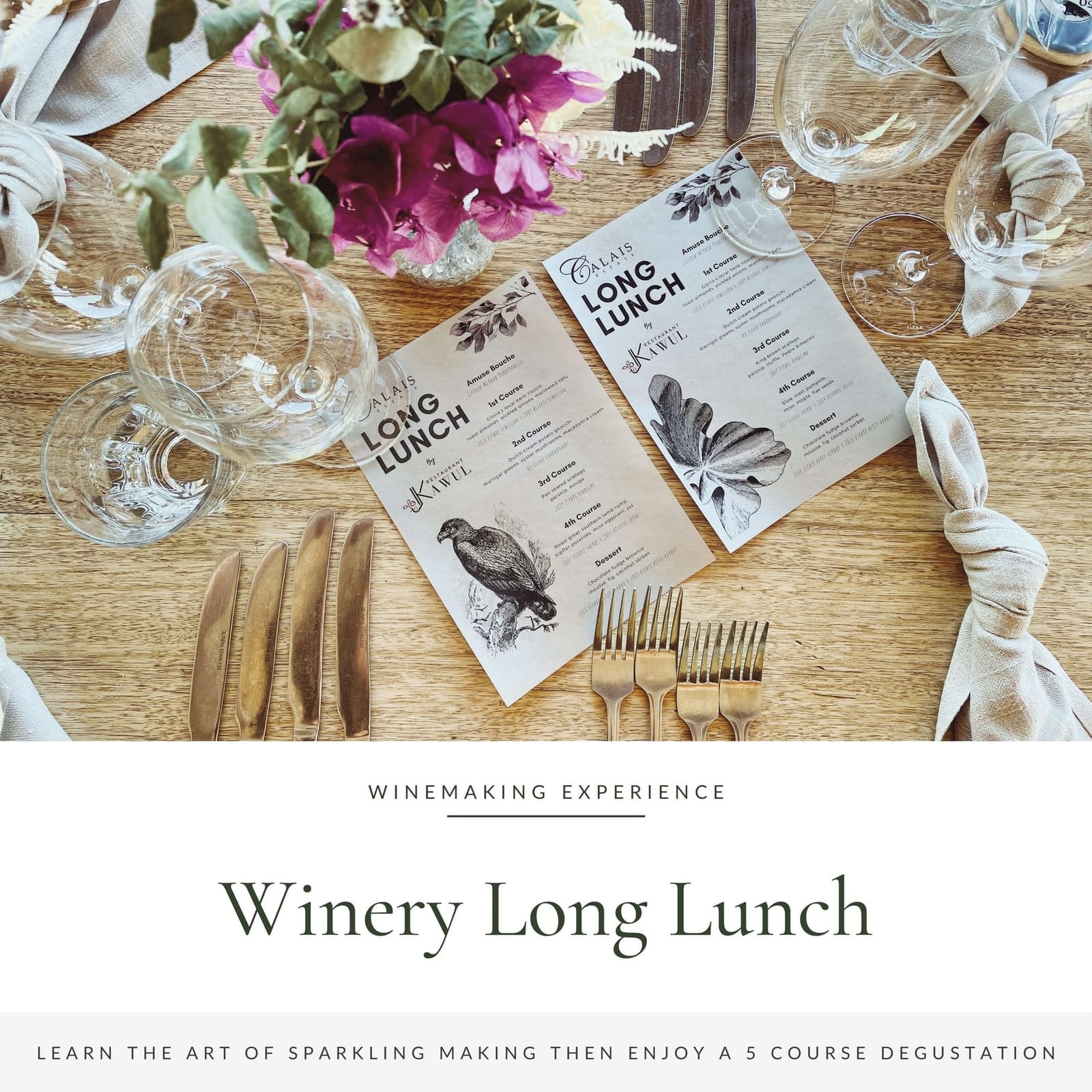 Long lunch table setting with menu, flowers and wine glasses