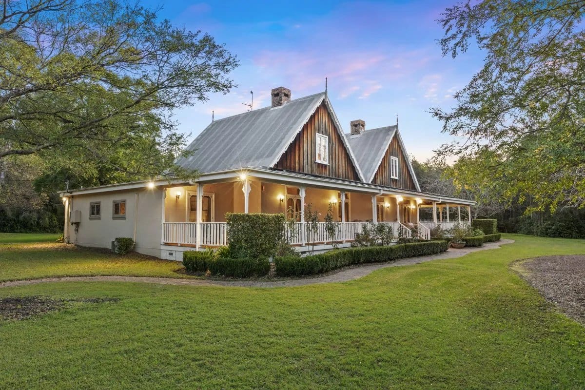 Victorian estate building with wrap-around porch at dusk at Carriages, Pokolbin, Hunter Valley