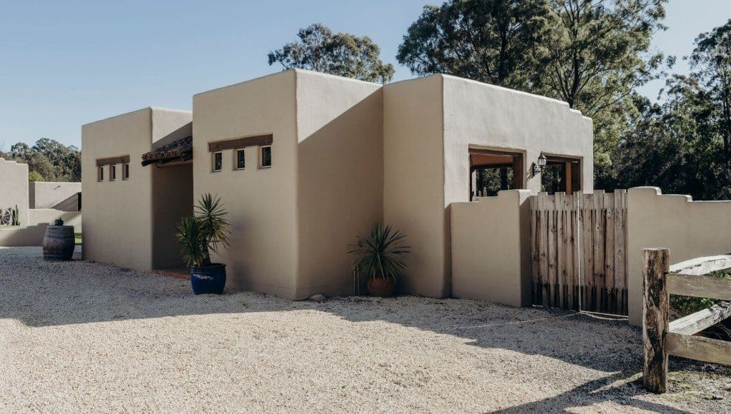 Spa Villa Three from the outside, rendered walls against the bush