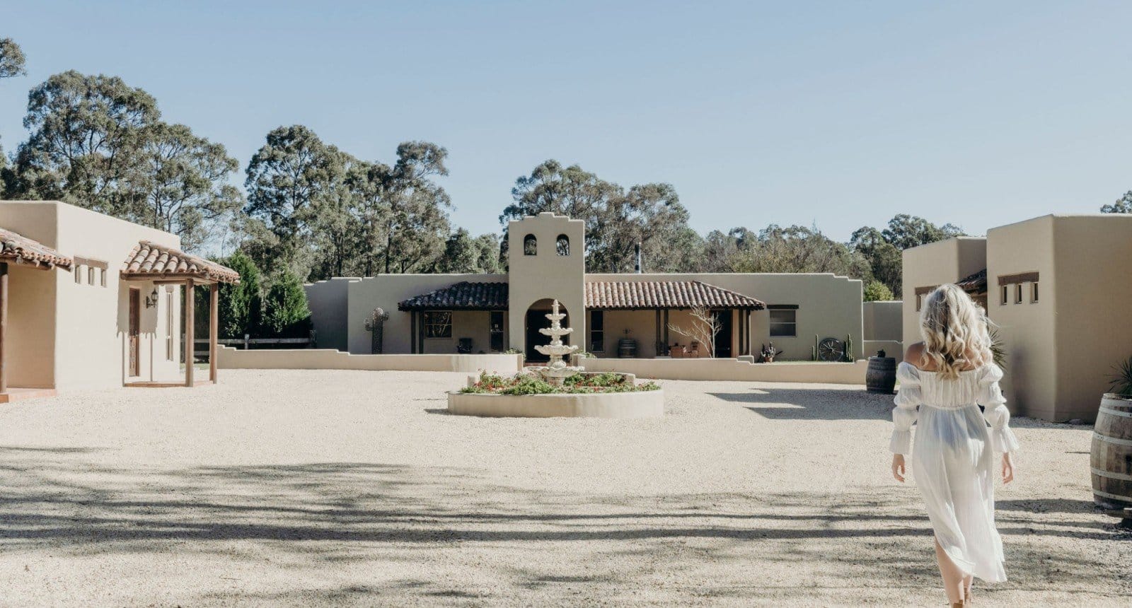 Rendered pueblo-style villas seen from the gravel drive at Casa La Vina, Pokolbin, Hunter Valley