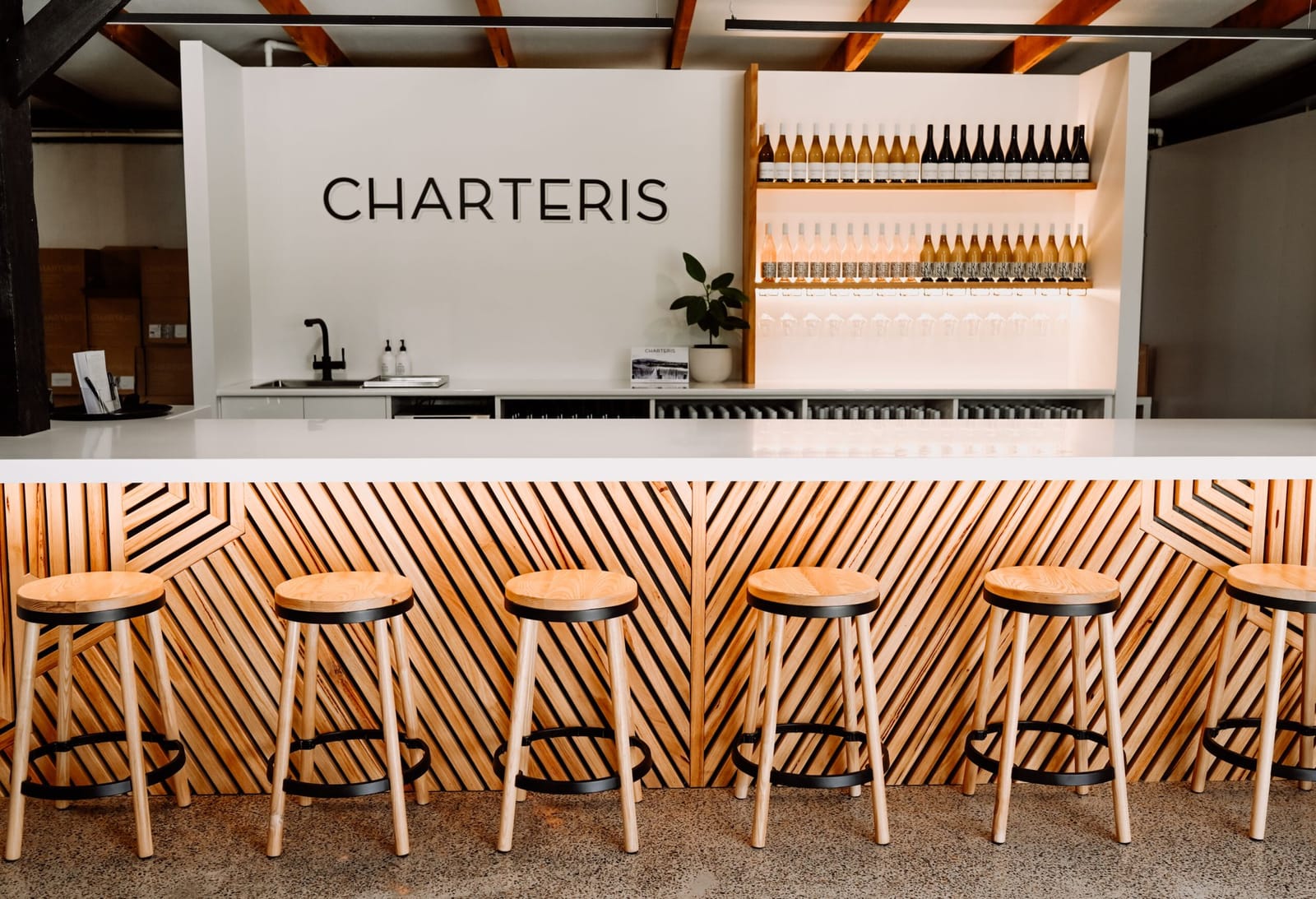 Modern cellar door bar with wine bottle display wall at Charteris, Pokolbin, Hunter Valley