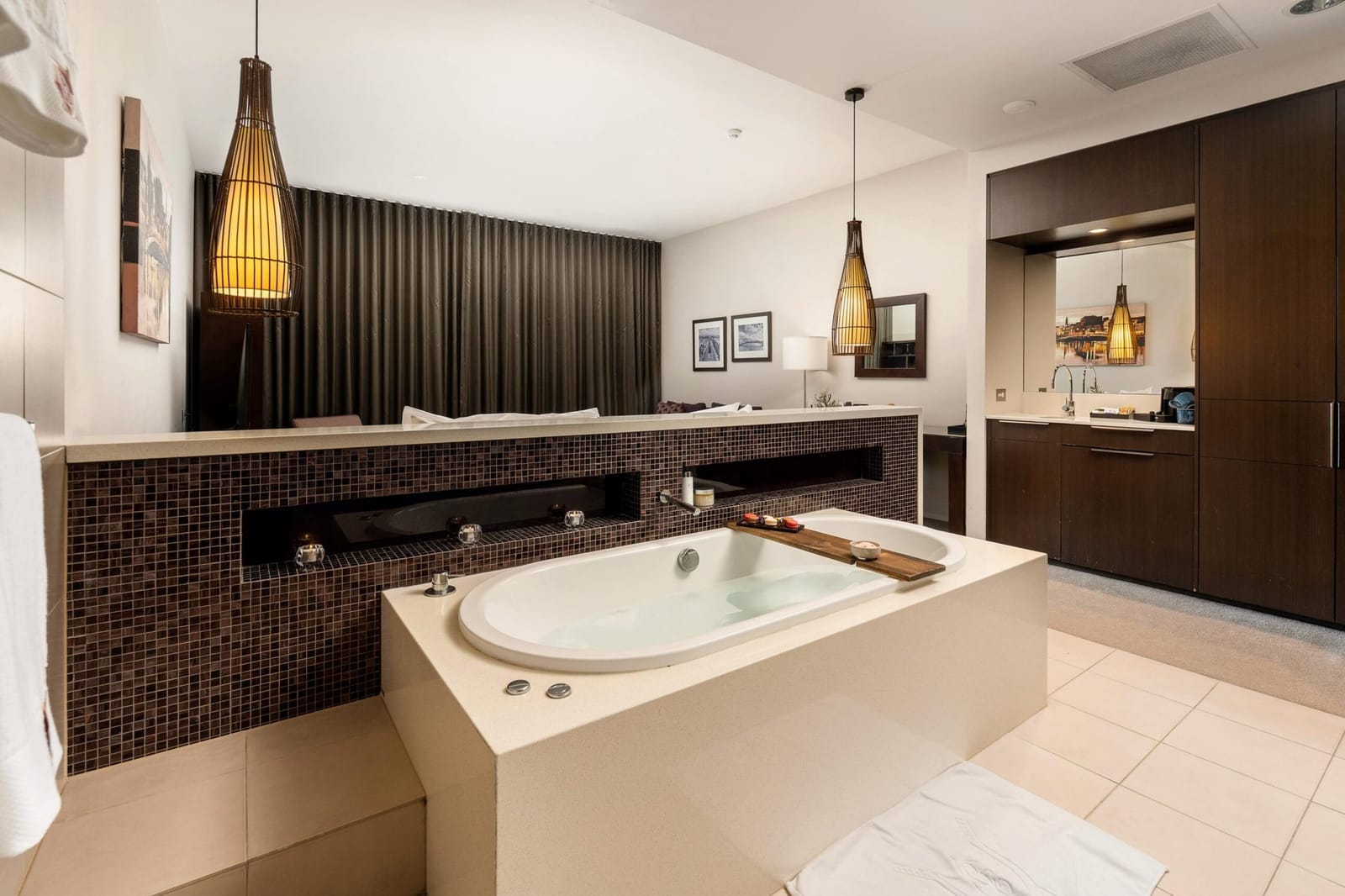 The deep spa bath in a Chateau Elan spa suite, open to the bedroom behind