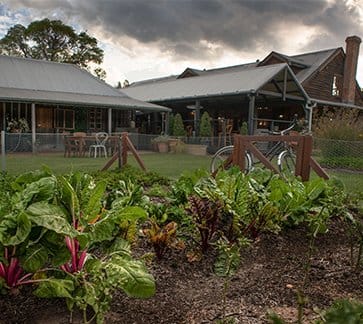 Restaurant exterior with vegetable garden and timber architecture