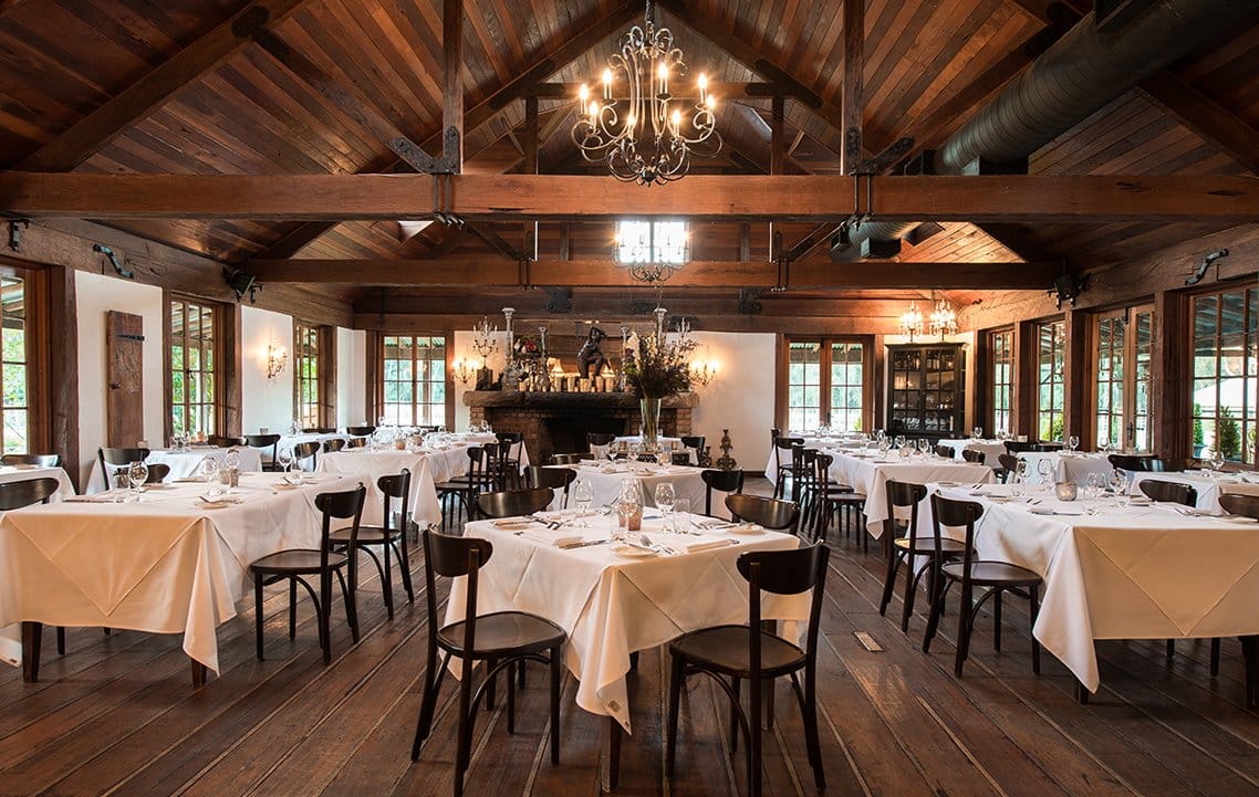 Grand timber dining hall with soaring roof and elegant table settings at Circa 1876, Pokolbin, Hunter Valley