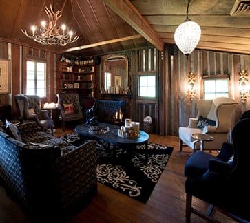 Timber lodge lounge with mounted antlers and leather seating