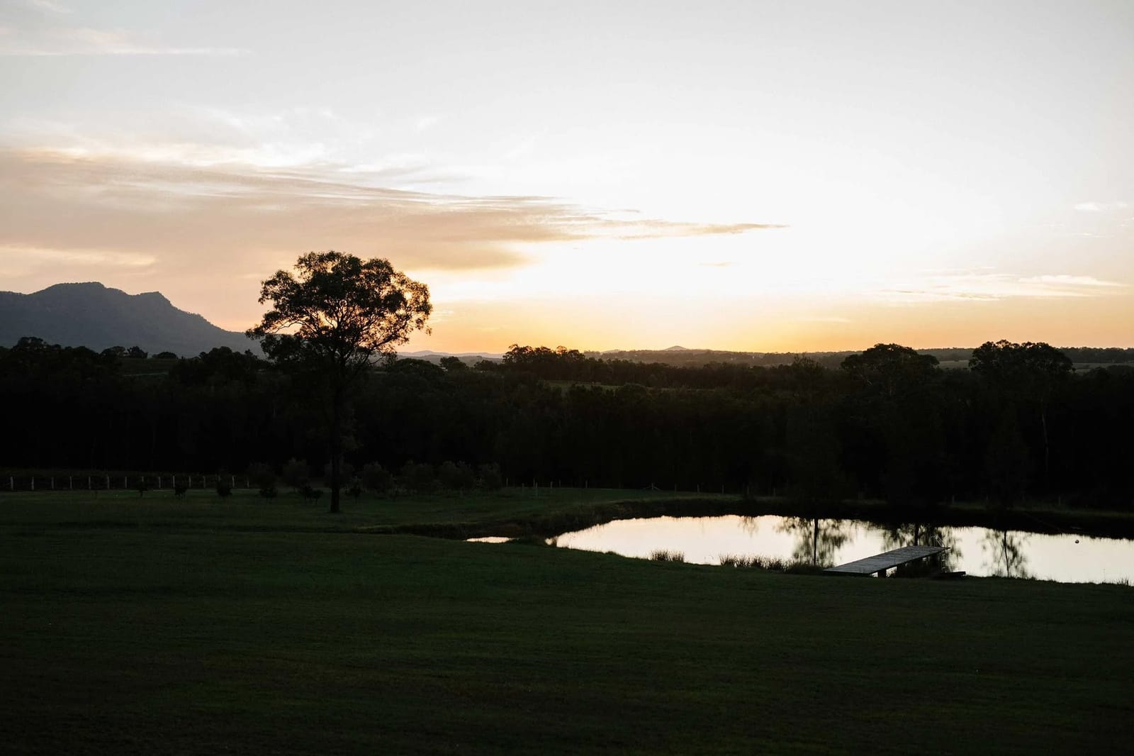 Estate grounds at sunset with pond and tree-lined landscape at Crossing Creek, Rothbury, Hunter Valley