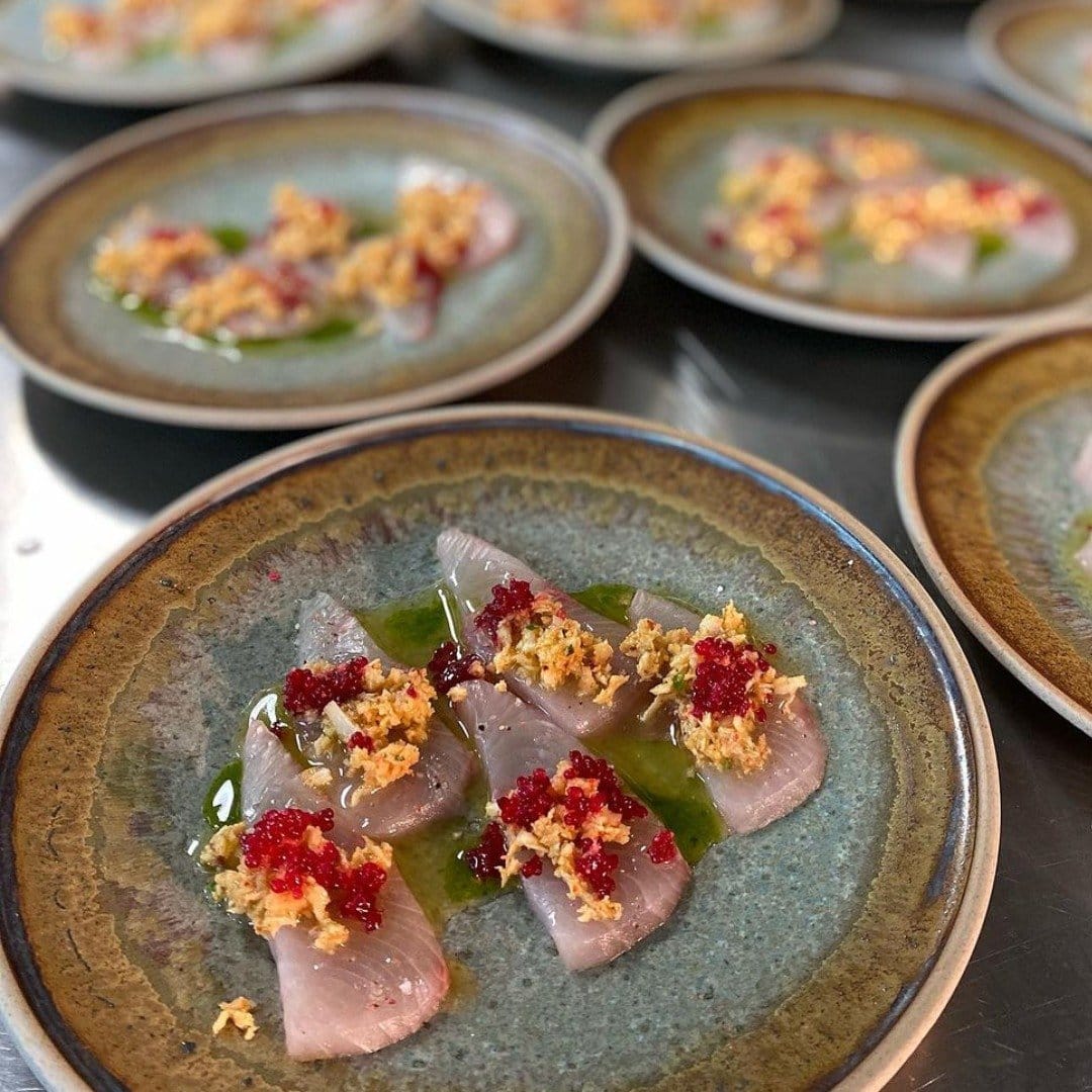 A plated raw fish dish with citrus dressing and roe served at Cypress Lakes Bistro & Bar.