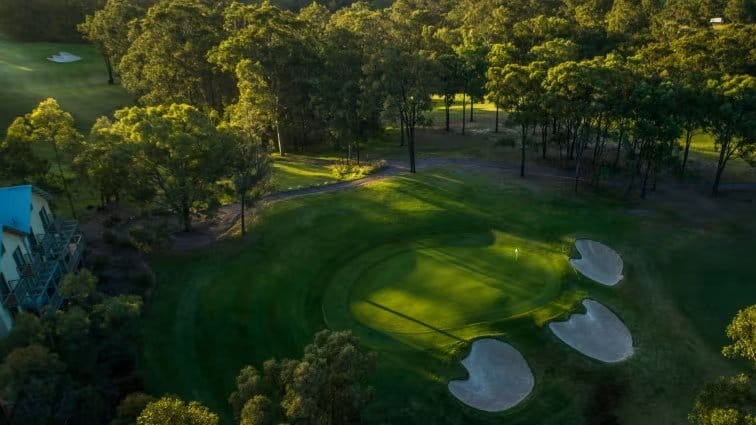Aerial view of golf course fairways and bunkers in parkland