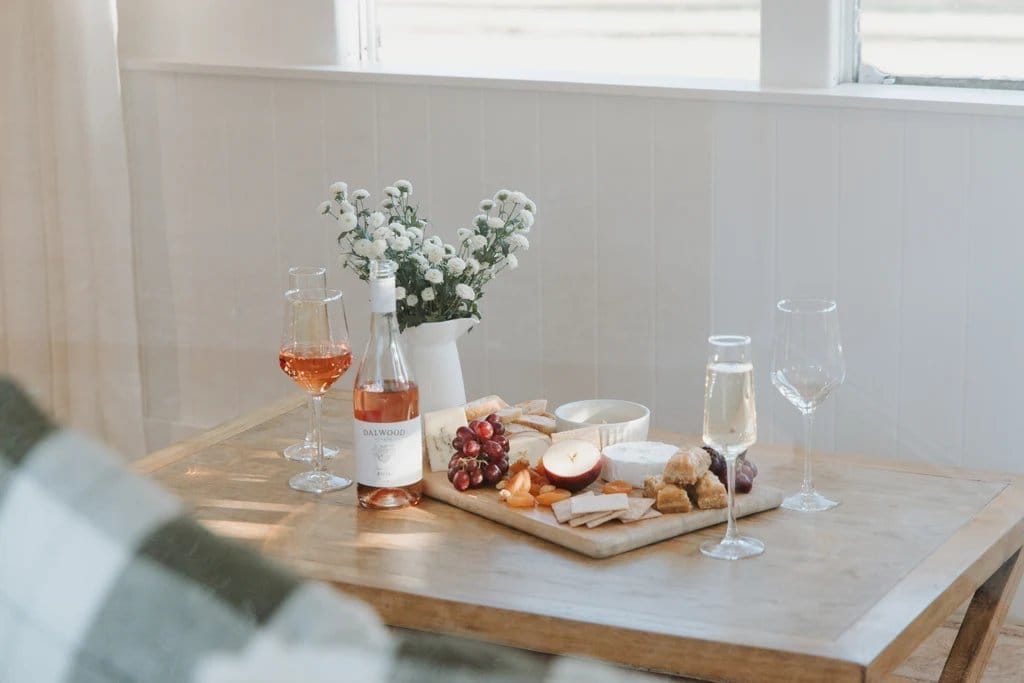 Wine and charcuterie tasting display with bottle, glass and food