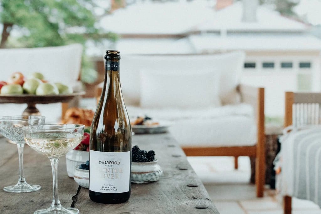 Wine bottle with label displayed on outdoor dining table setting