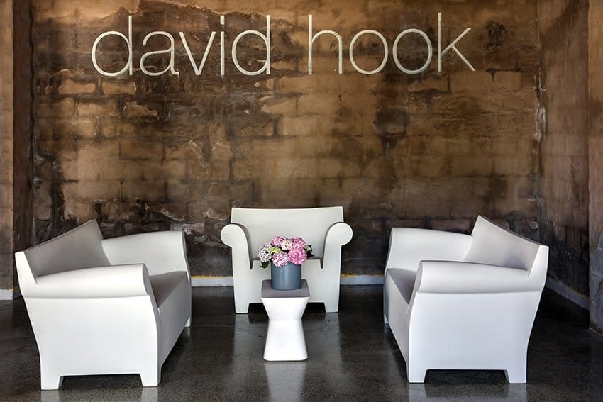 Modern tasting room with white furniture and brick feature wall at David Hook, Belford, Hunter Valley