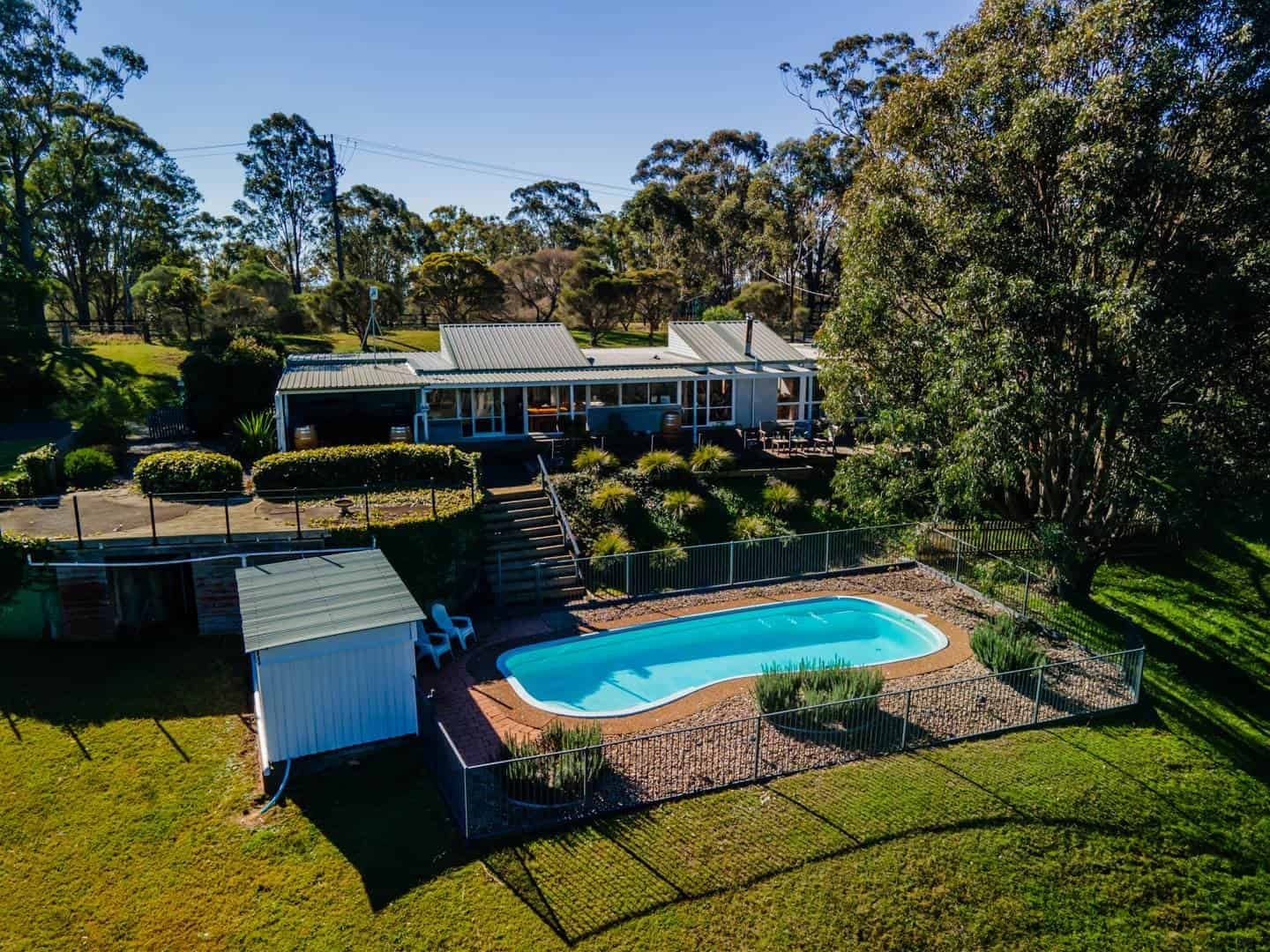 Modern hotel building with pool overlooking vineyard landscape at Englewood Ridge, Lovedale, Hunter Valley