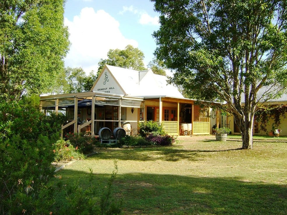 Heritage winery building with verandah surrounded by established trees at Ernest Hill, Nulkaba, Hunter Valley