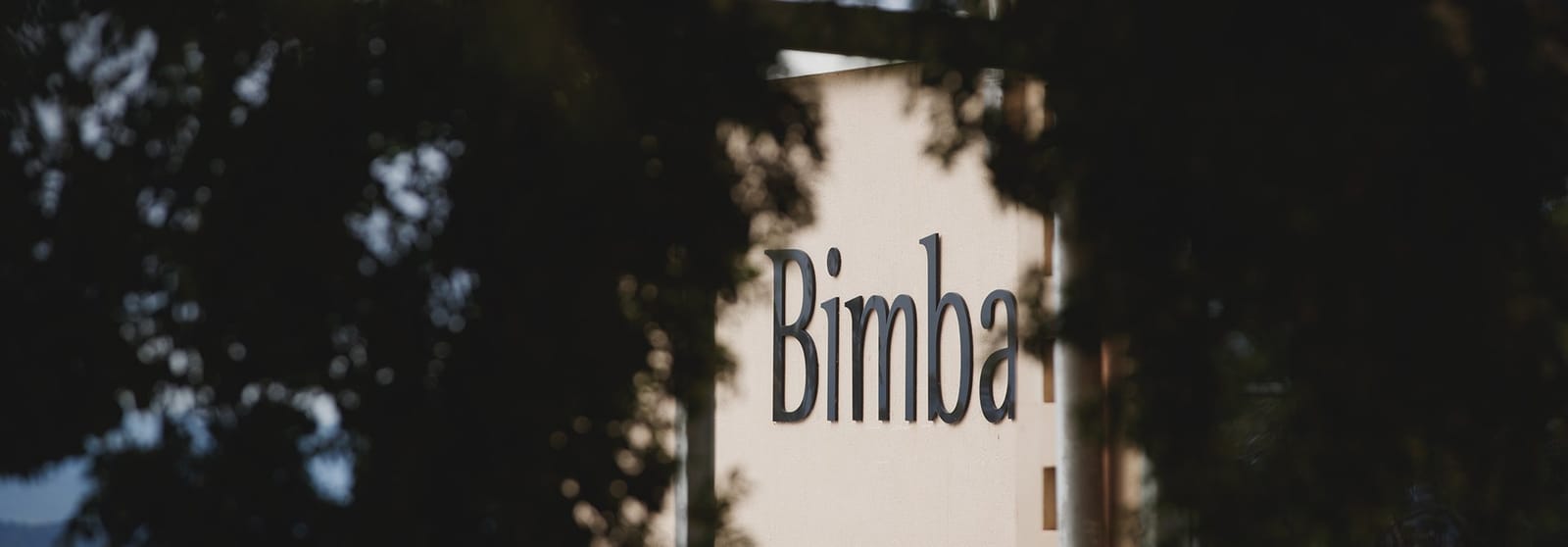 Estate entrance signage among trees at Esca at Bimbadgen, Pokolbin, Hunter Valley