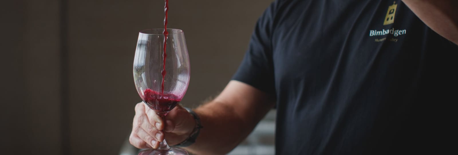 Bimbadgen staff pouring red wine for a guest