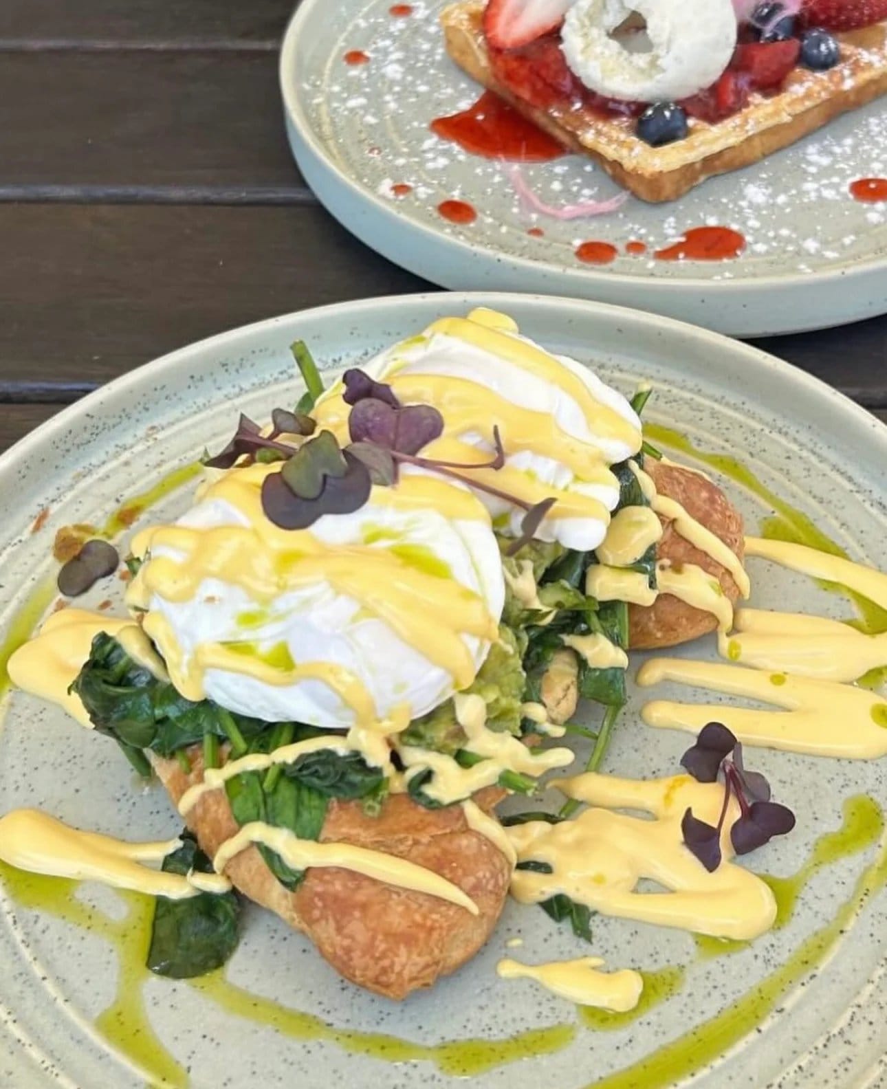 Poached eggs with hollandaise over spinach and toast at Flock & Fork.