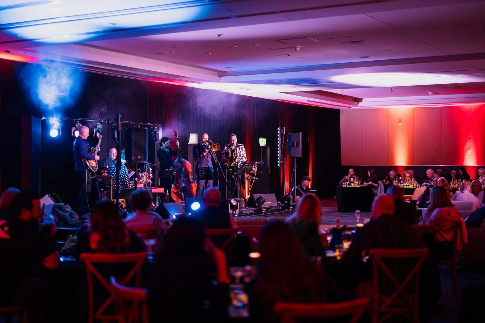 Live jazz band performing for diners under blue and red stage lighting at GATHER, Lovedale, Hunter Valley