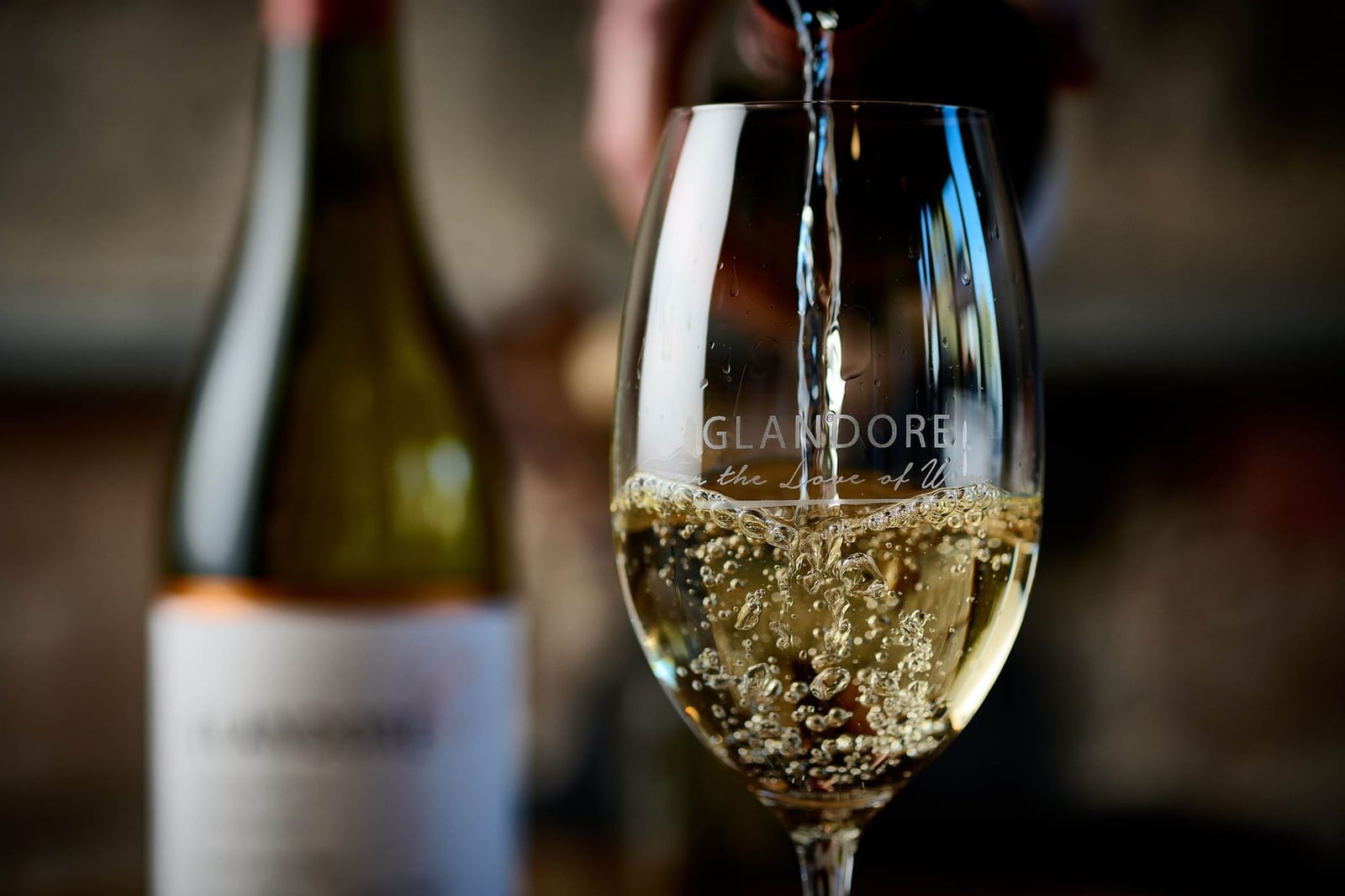 Wine being poured into a branded glass with aroma expression at Glandore Estate, Pokolbin, Hunter Valley