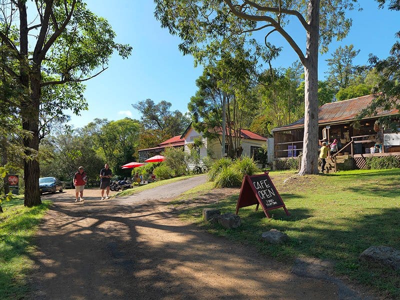 Estate grounds with historic buildings, cafe facilities and shaded tree canopy