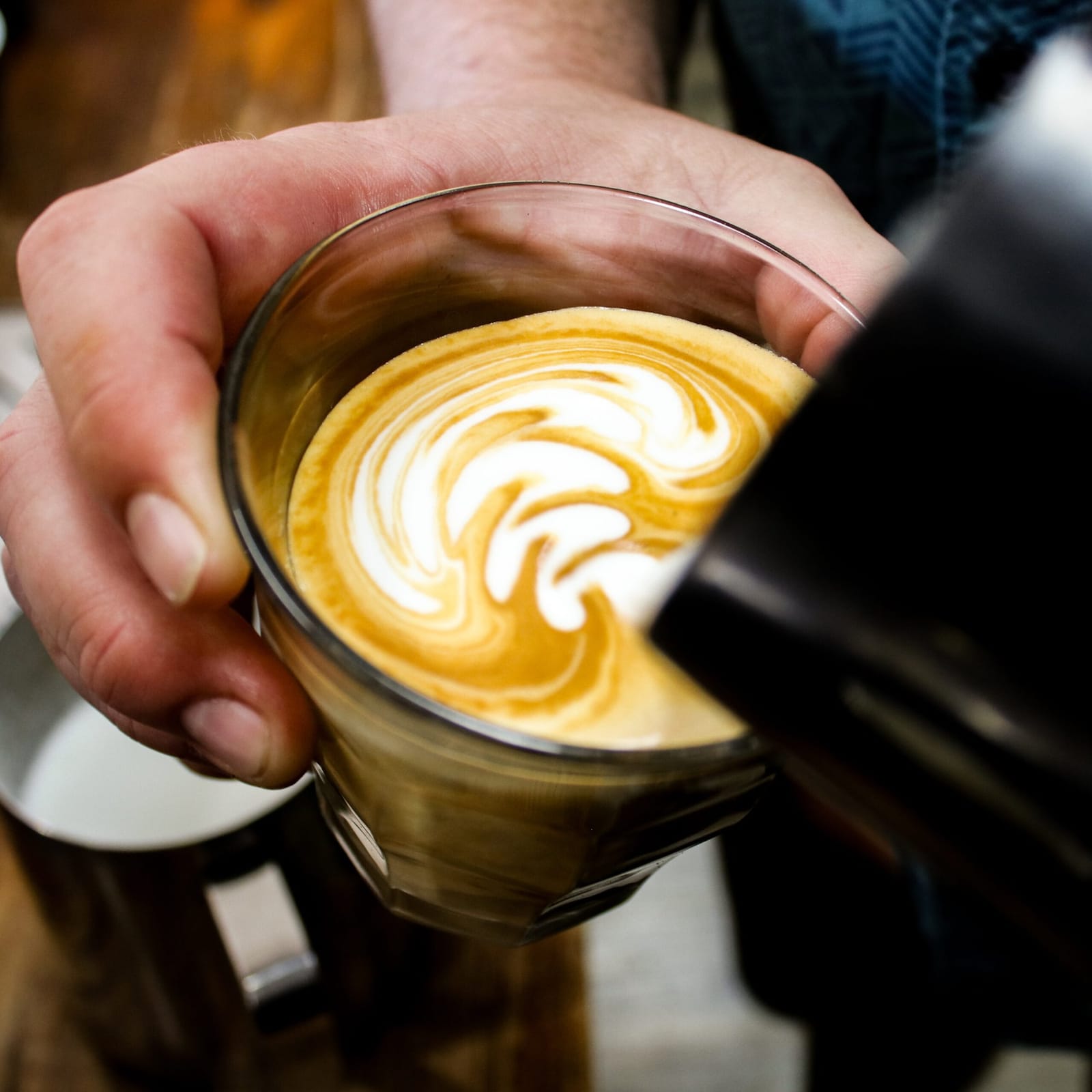 Barista pouring latte art at Greg's Espresso Bar, Pokolbin, Hunter Valley