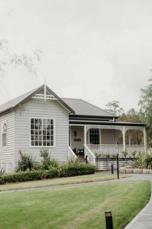 Gow House, a heritage weatherboard building with a wraparound verandah at Greystone Estate.