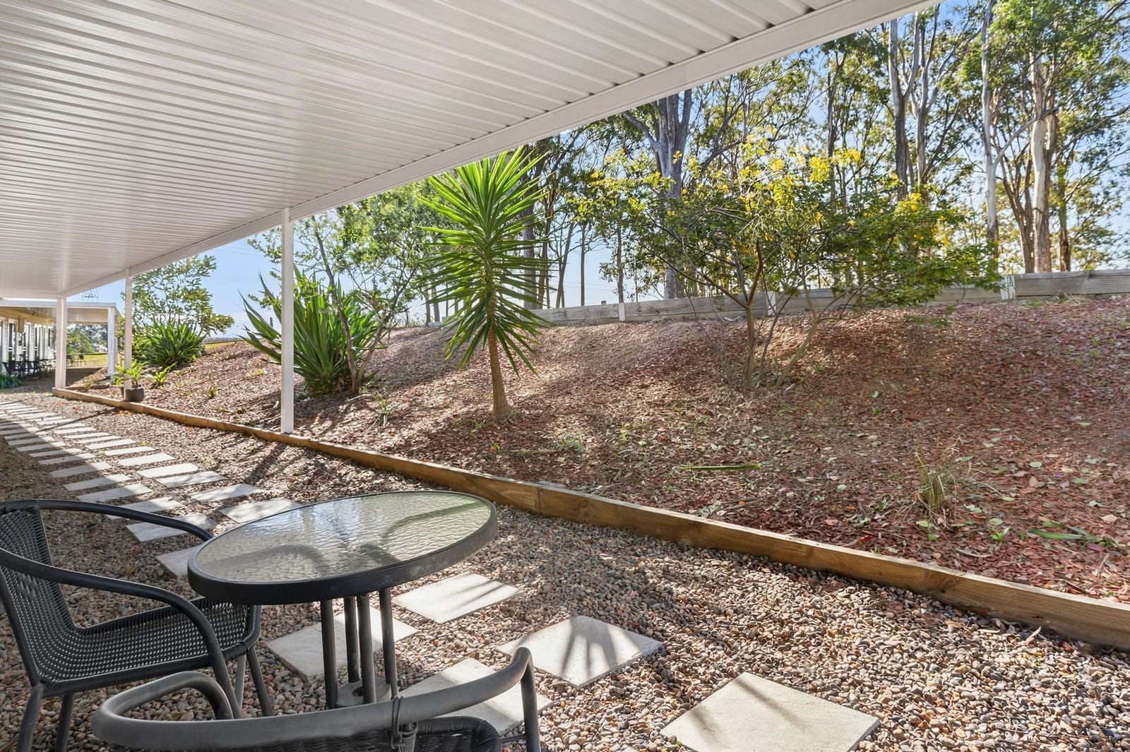 The paved terrace and plantings outside the villas