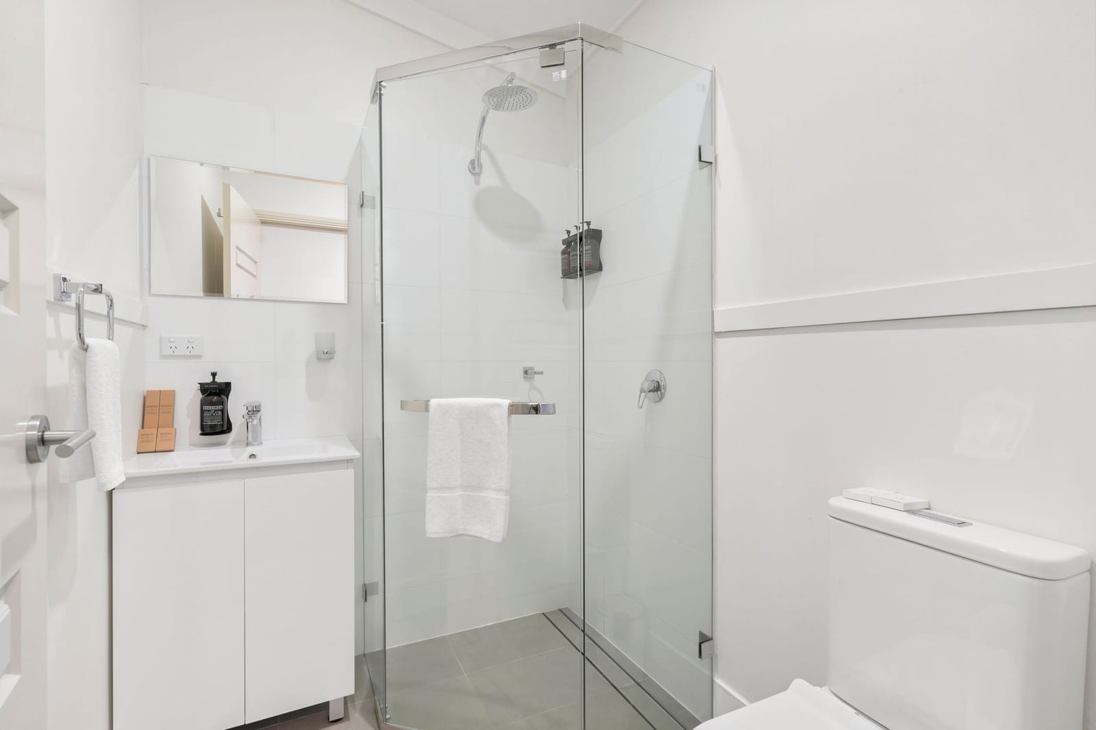 An ensuite bathroom with a glass walk-in shower
