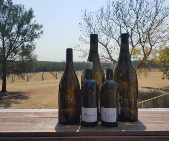 Wine bottles on table overlooking Hart & Hunter vineyard landscape